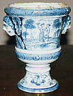 A footed pot with Dutch and oriental decorative motifs.